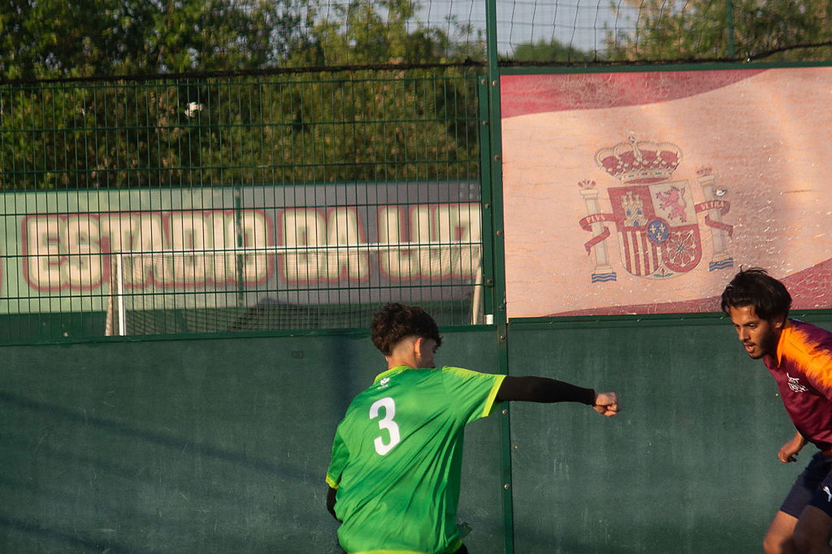 A Street Trials trialist shields the ball from an opponent on the 7-a-side pitch at Goals Football Manchester