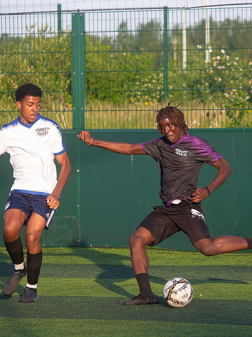 A Street Trials player strikes the ball in front of a defender