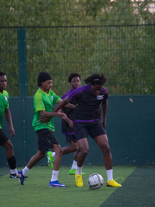 Players compete for possession in a crowded midfield
